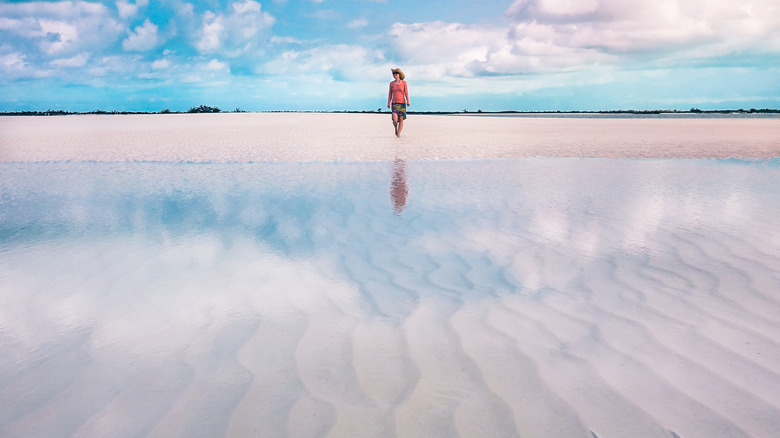 Woman walking on a sandbar 